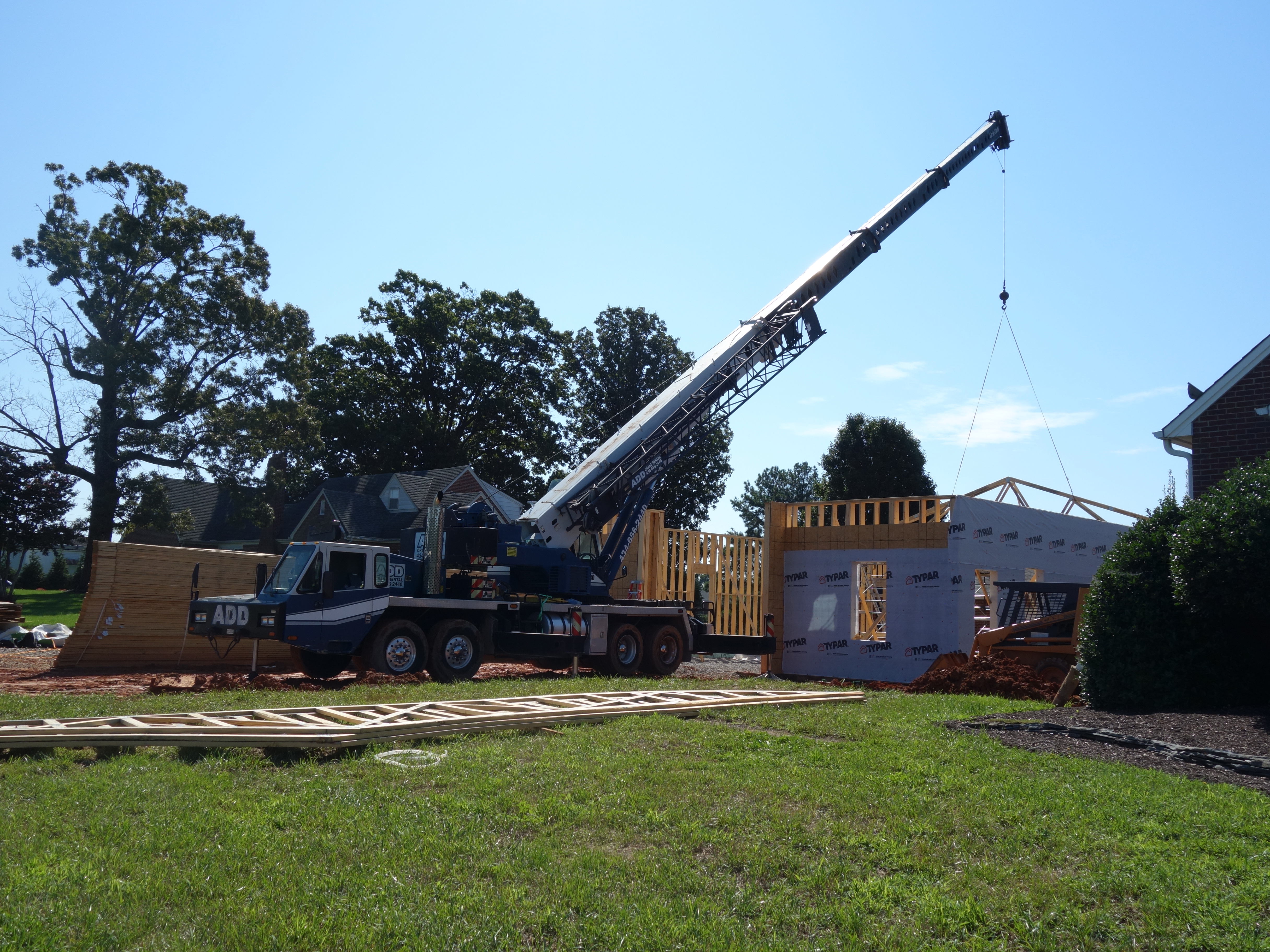 Crane hoisting roof frame