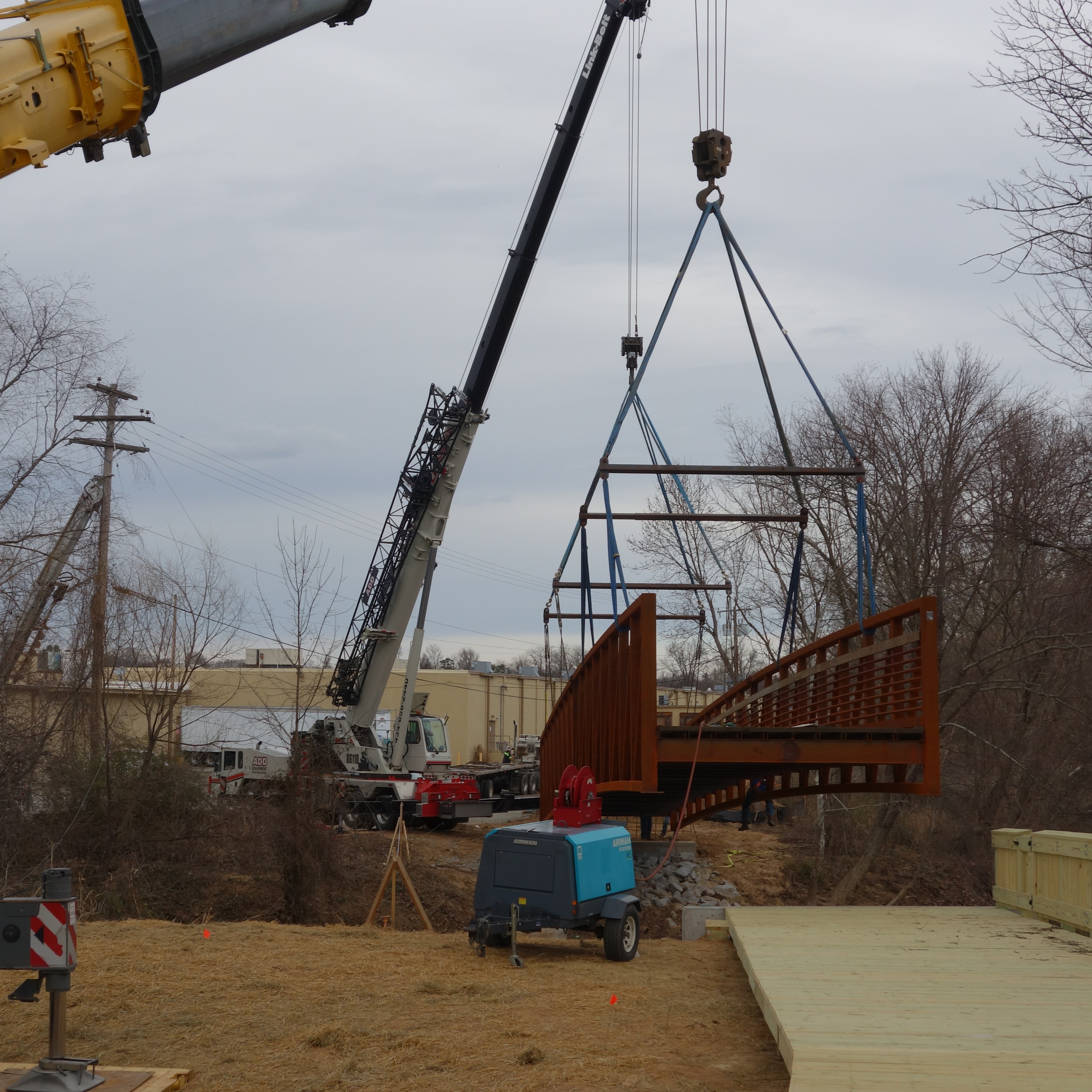 bridge section over river with crane